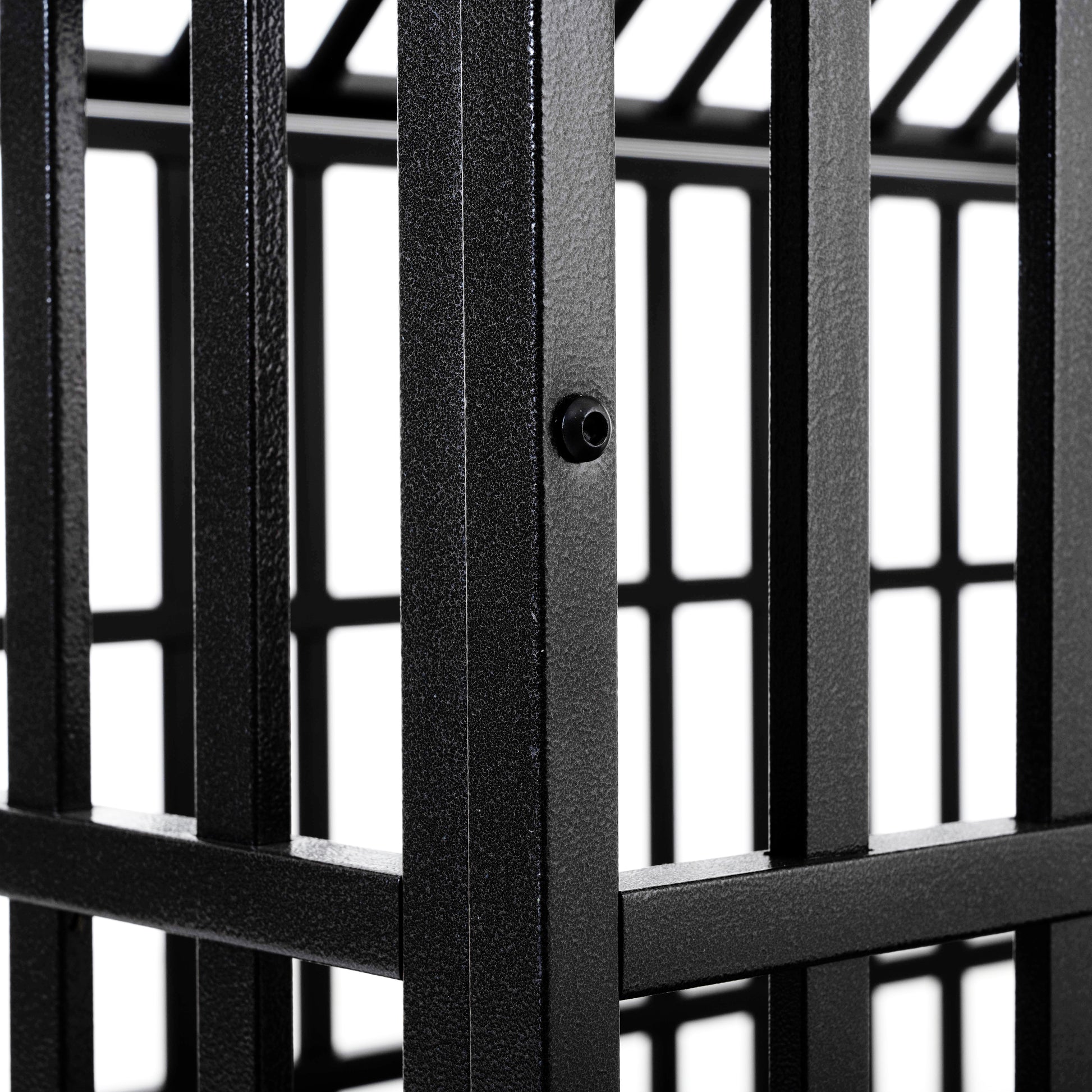Closeup of textured black metal frame part of a dog crate