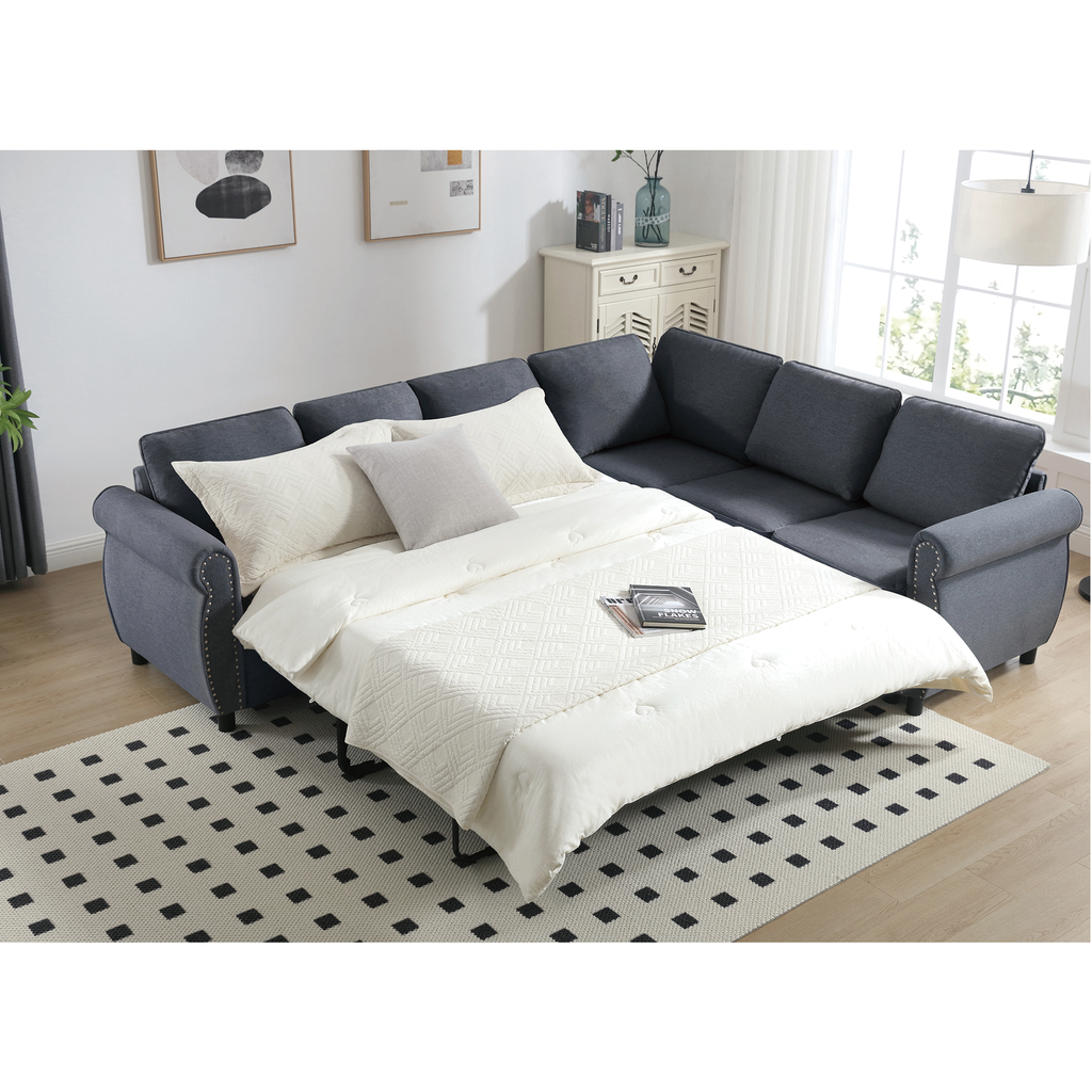 Dark gray fabric sectional sofa bed with white bedding and decorative pillows
