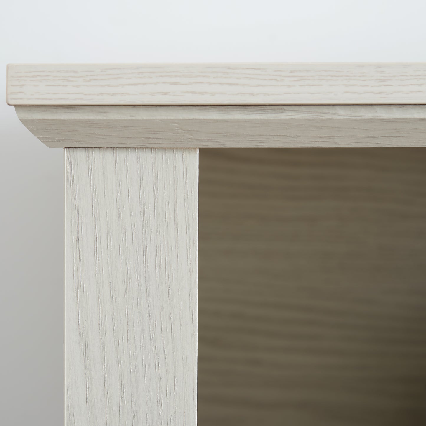 Closeup of light oak laminate wood grain detail on cabinet edge