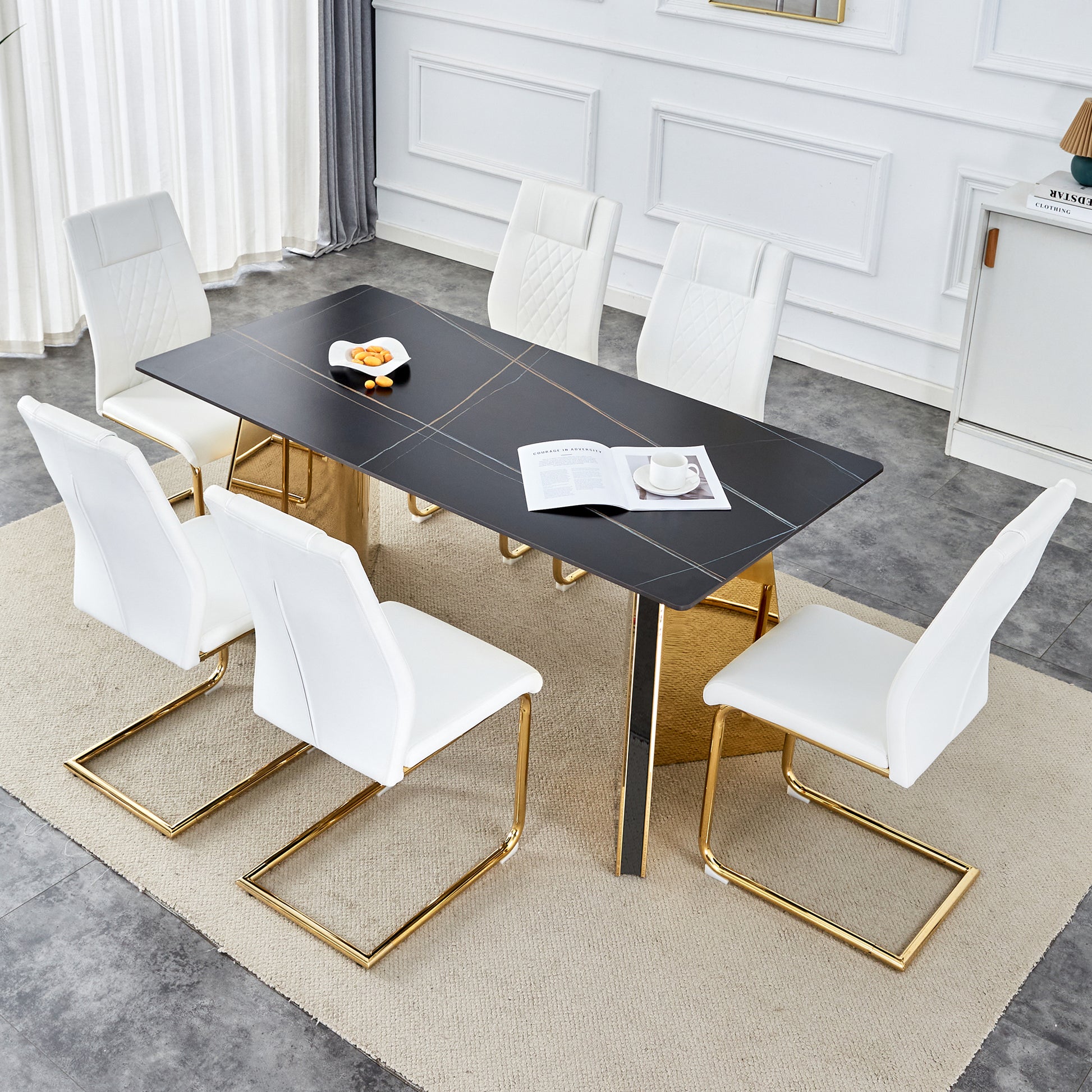 Black marble dining table with gold accents and white leather chairs