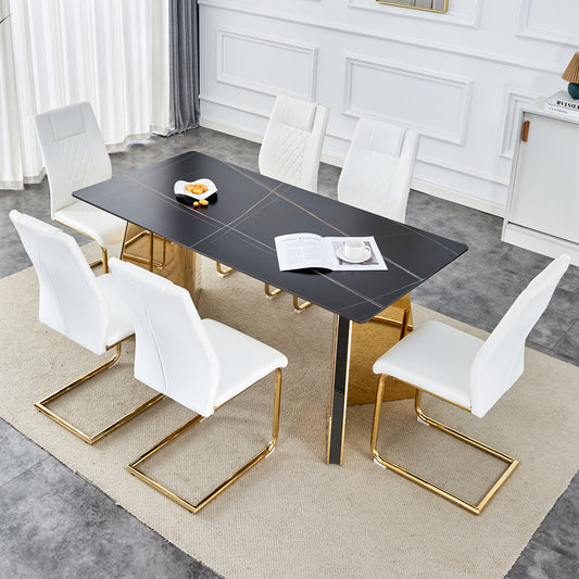 Black marble dining table with gold accents and white leather chairs