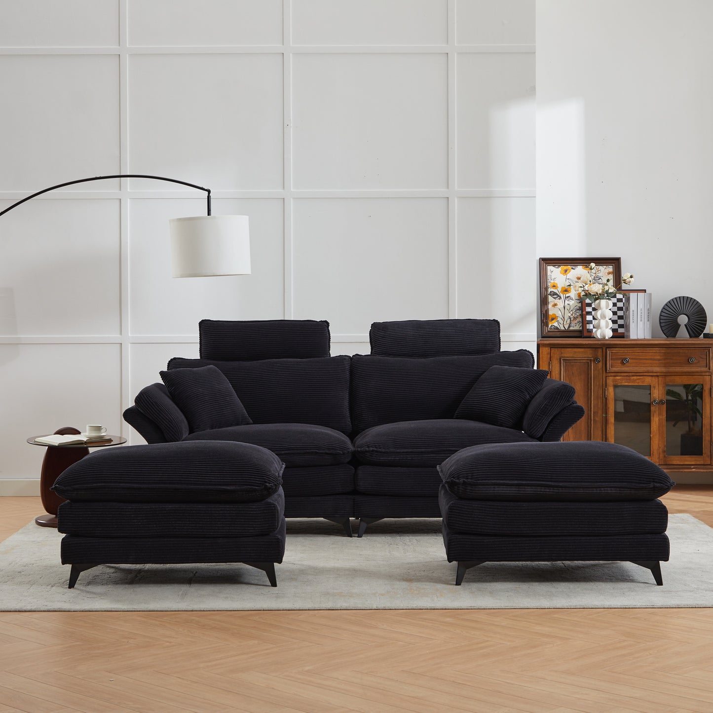 Plush black corduroy sectional sofa with deep seats and matching ottomans for a cozy living room setup