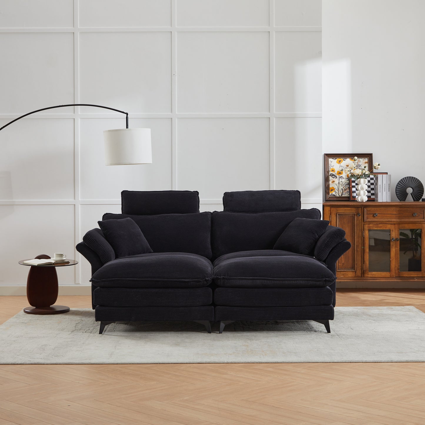 Plush black corduroy sofa with deep cushions and adjustable headrests perfect for a modern living room