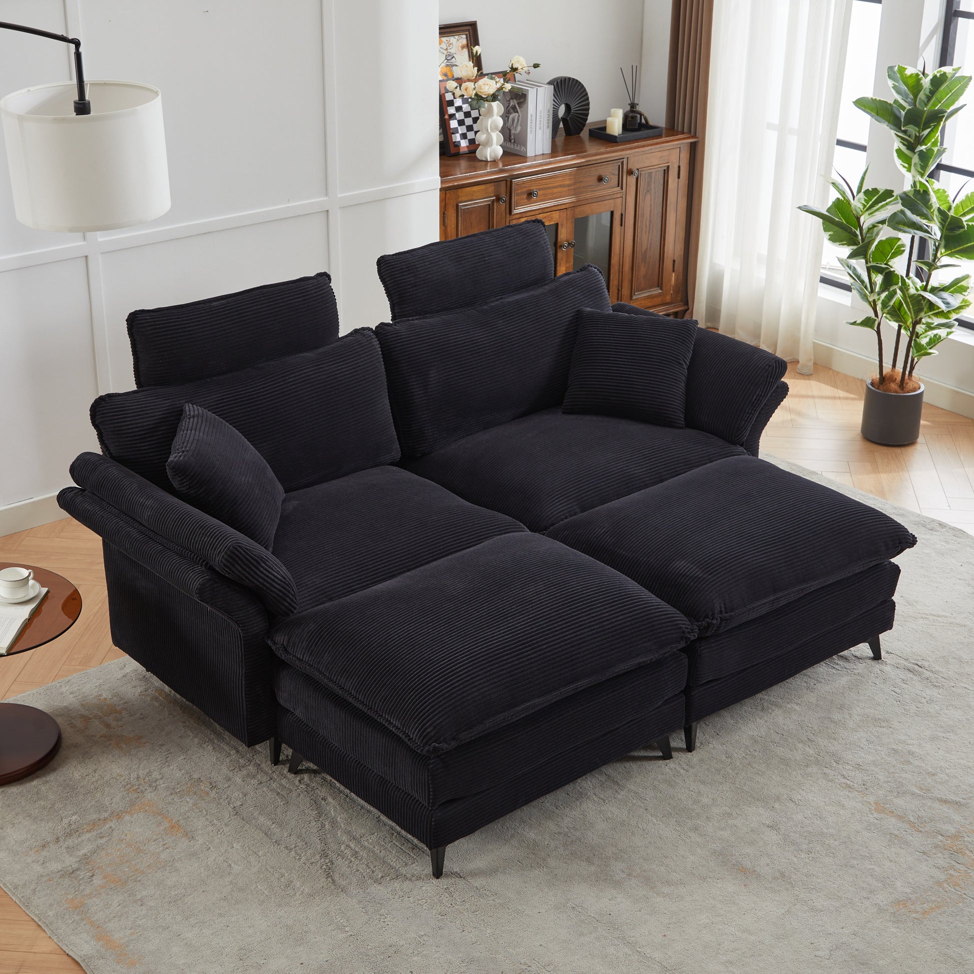 Plush black corduroy sectional sofa with deep seats and adjustable headrests