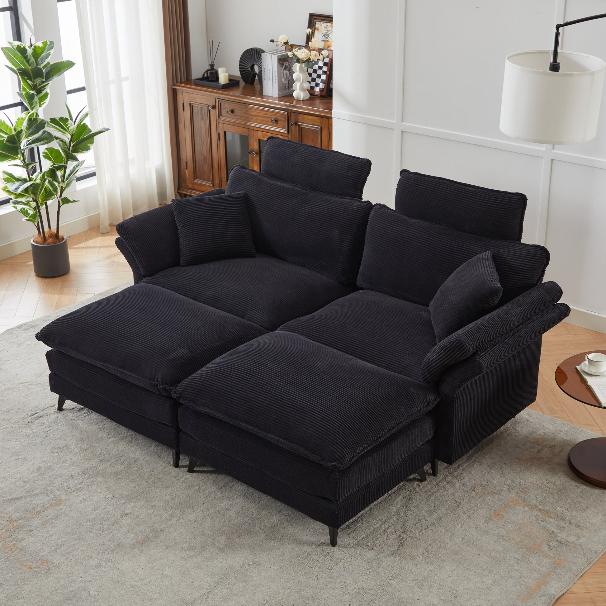 Sectional corduroy sofa in black with plush cushions and removable bolsters