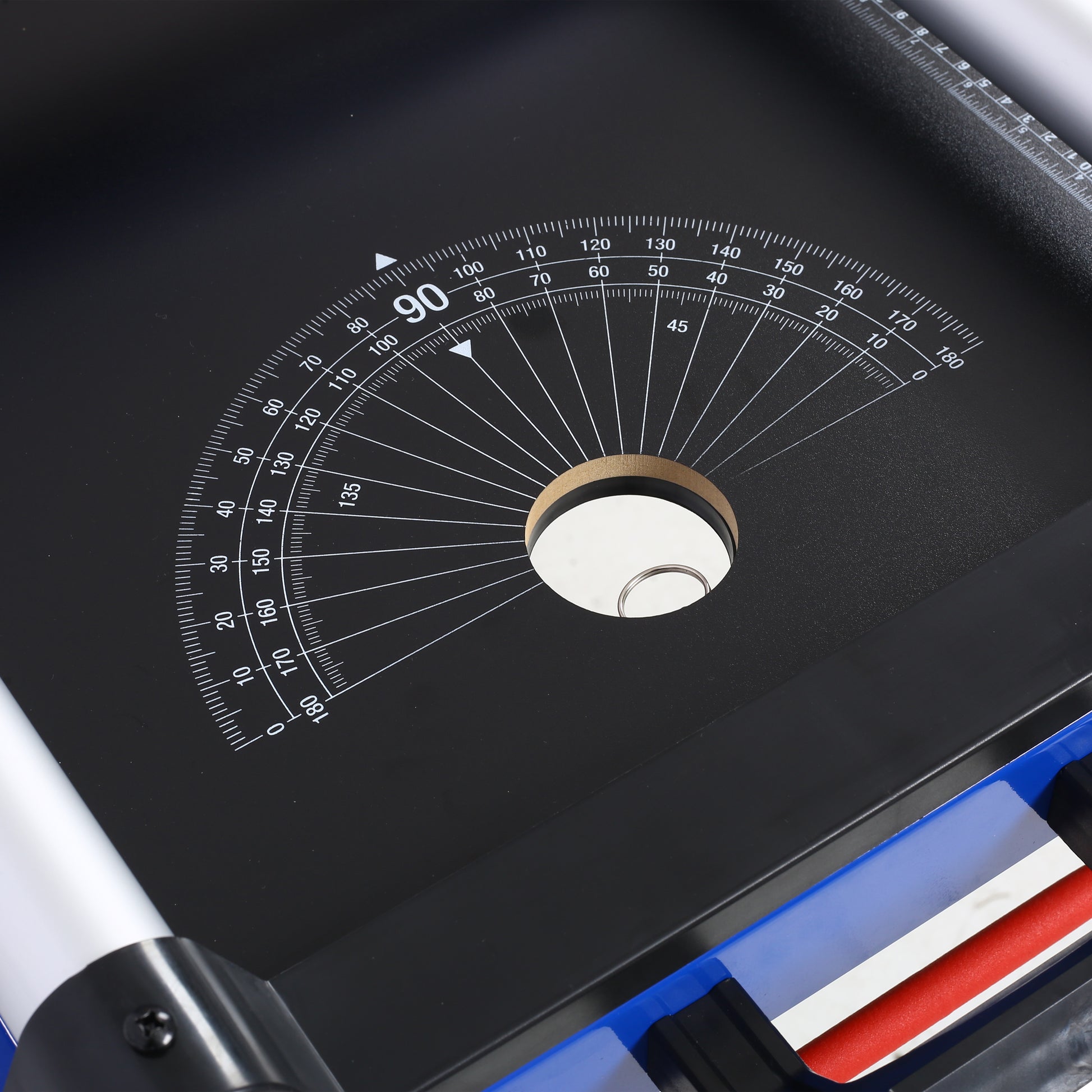 Black drafting table surface with white angle measurements and a central swivel point for precision