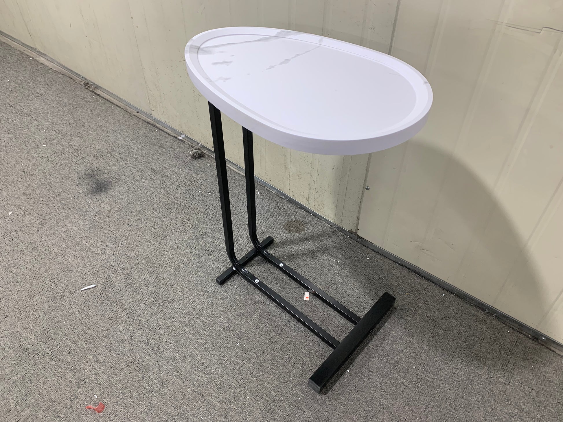 Oval marblelook top Ctable with black metal base perfect for small spaces