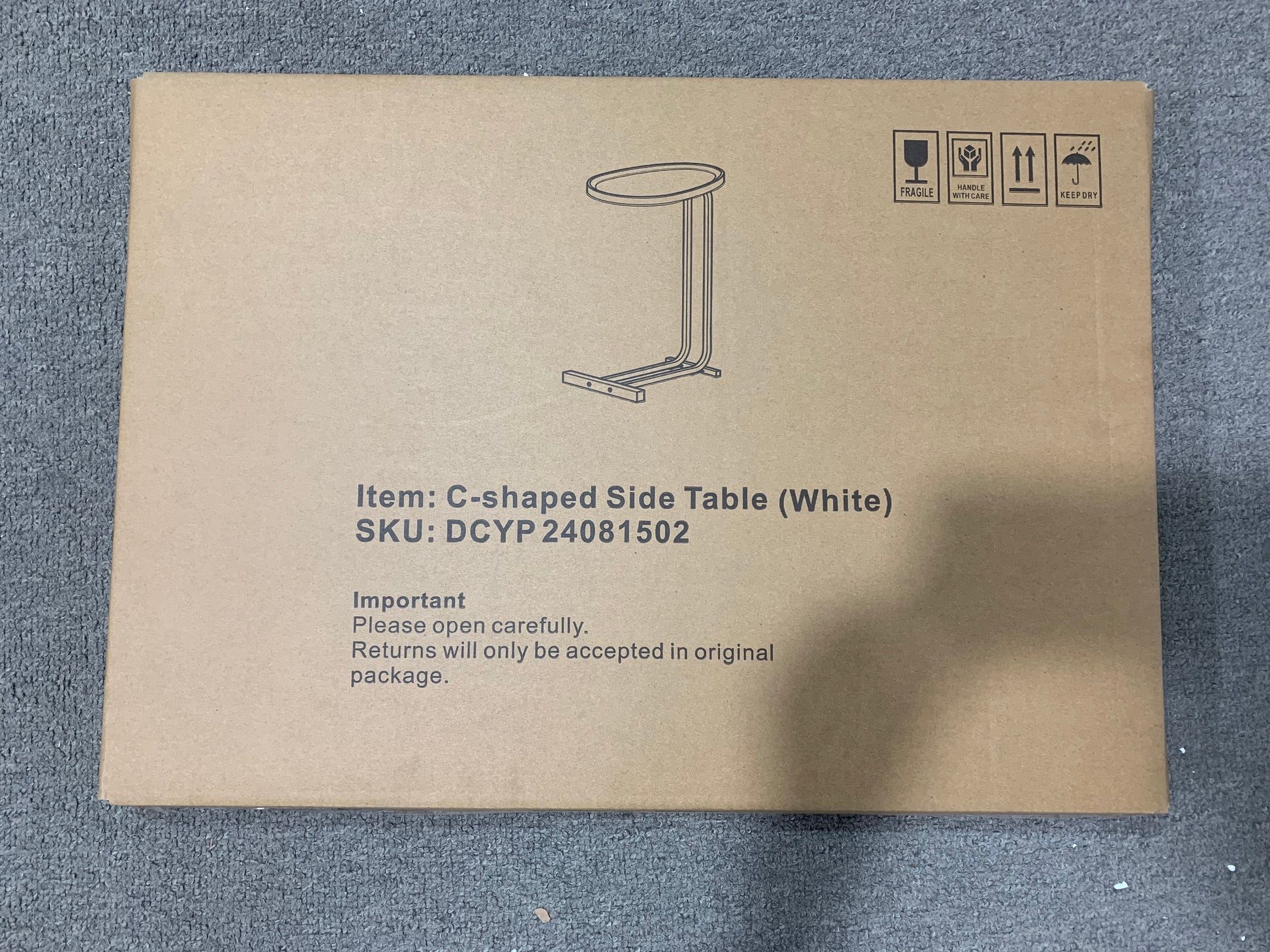 Cshaped side table White packaging with shipping symbols fragile handle with care this way up keep dry