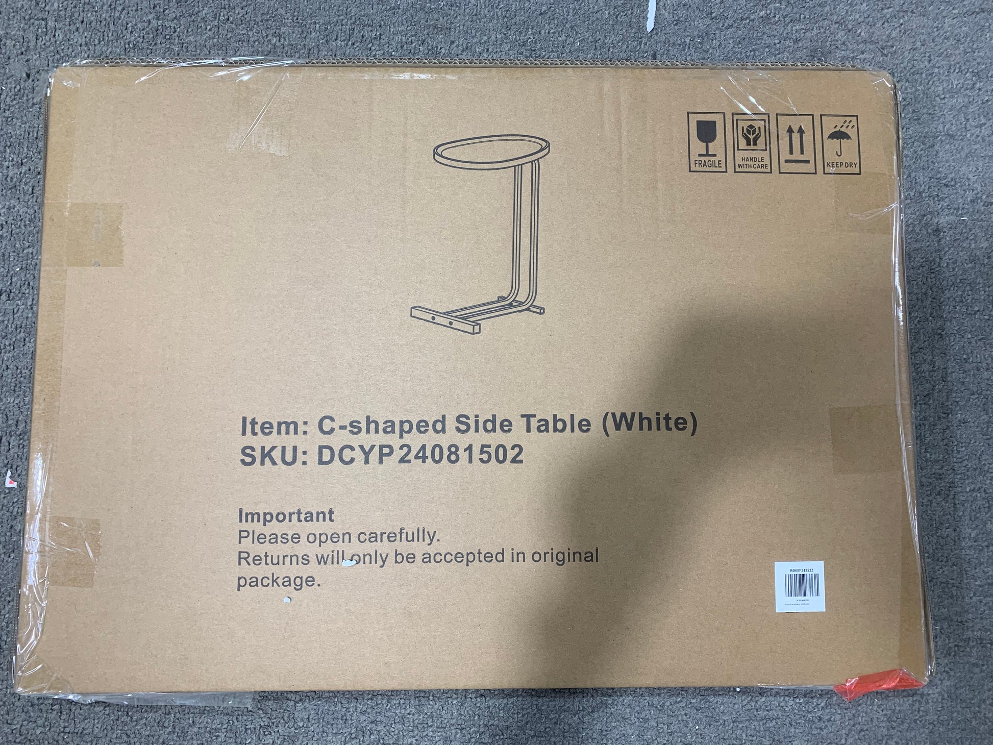 Line drawing of a white Cshaped side table on a cardboard box