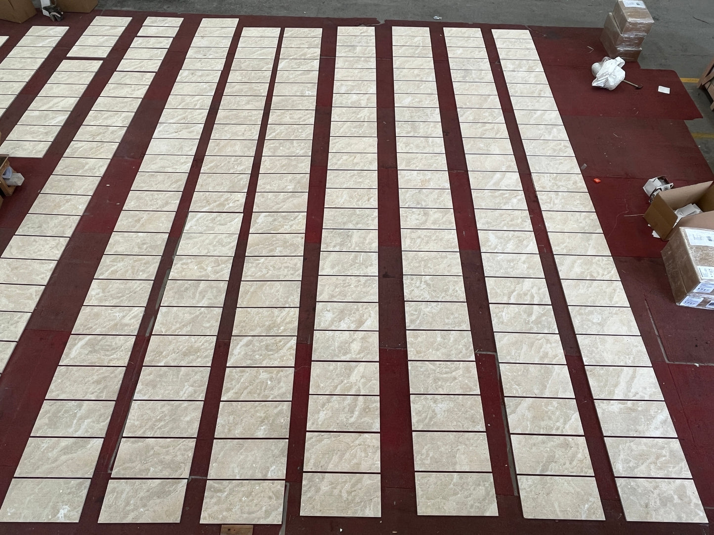 Beige marblelook ceramic tiles laid out in rows for home flooring projects