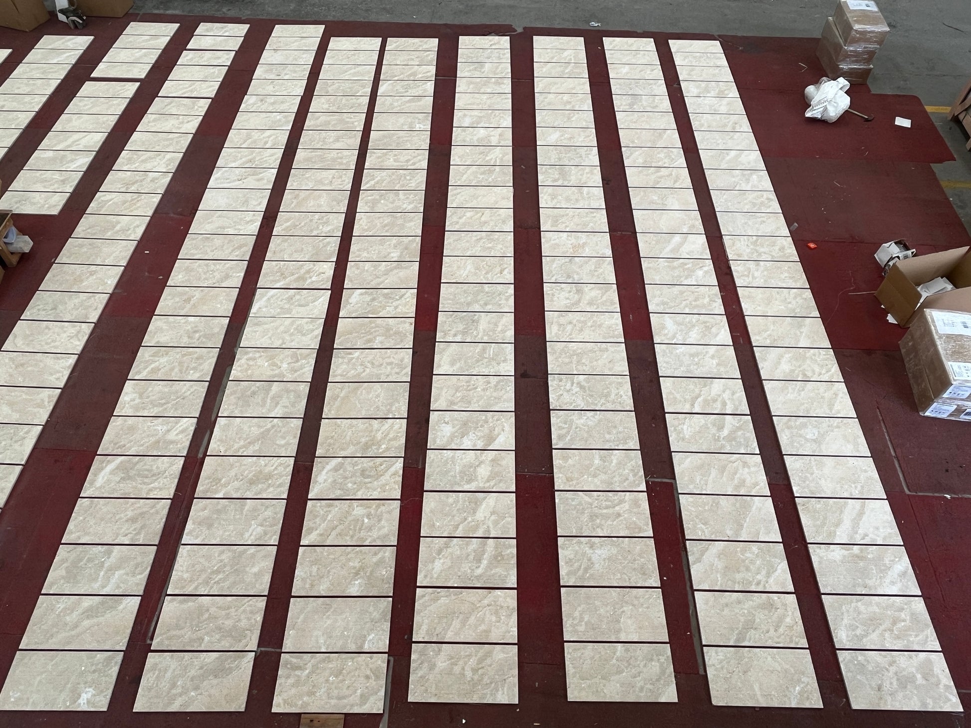 Beige marblelook ceramic tiles laid out in rows for home flooring projects