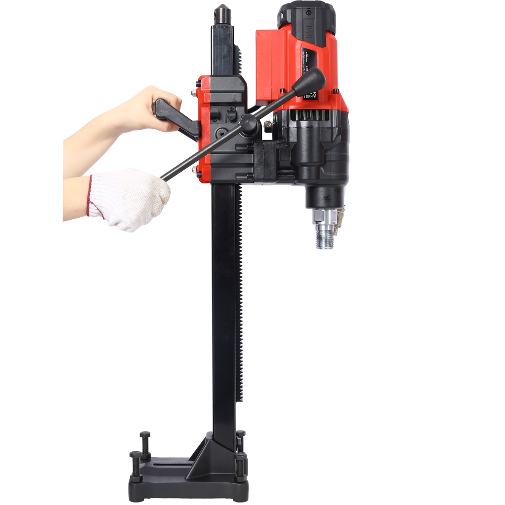 Red and black electric core drill with adjustable handle and sturdy base