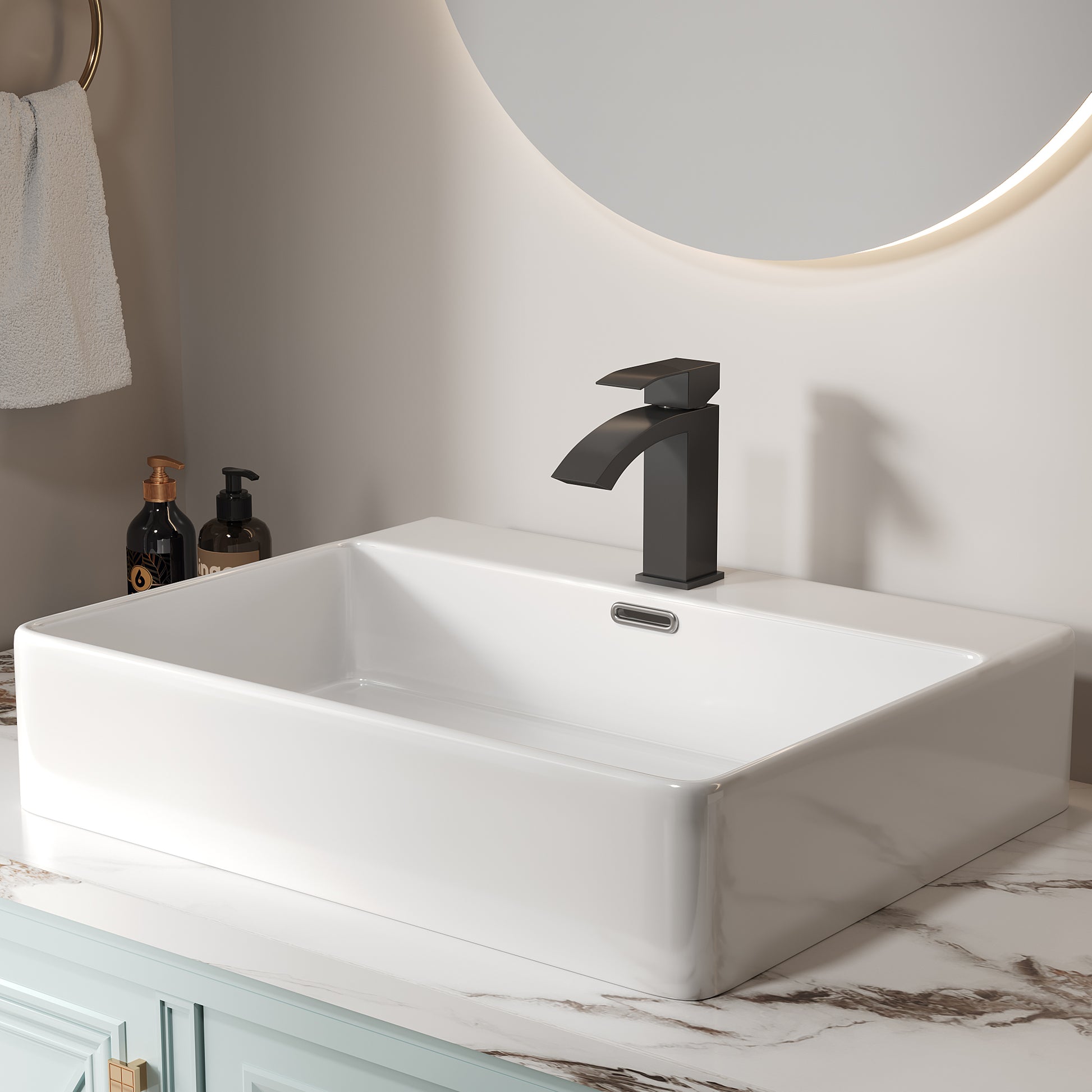 Modern matte black waterfall bathroom faucet on a white rectangular sink
