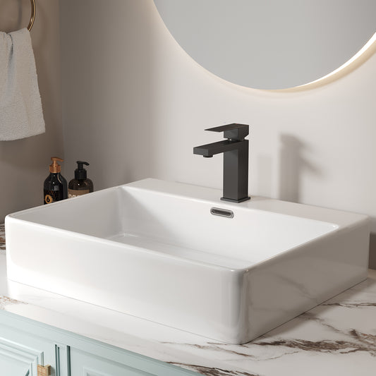 Modern black matte bathroom faucet installed on a rectangular white ceramic basin