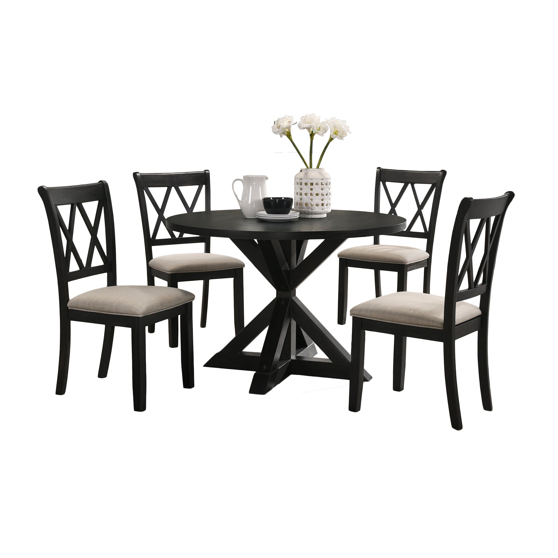 Round black pedestal dining table with four black chairs with beige cushions