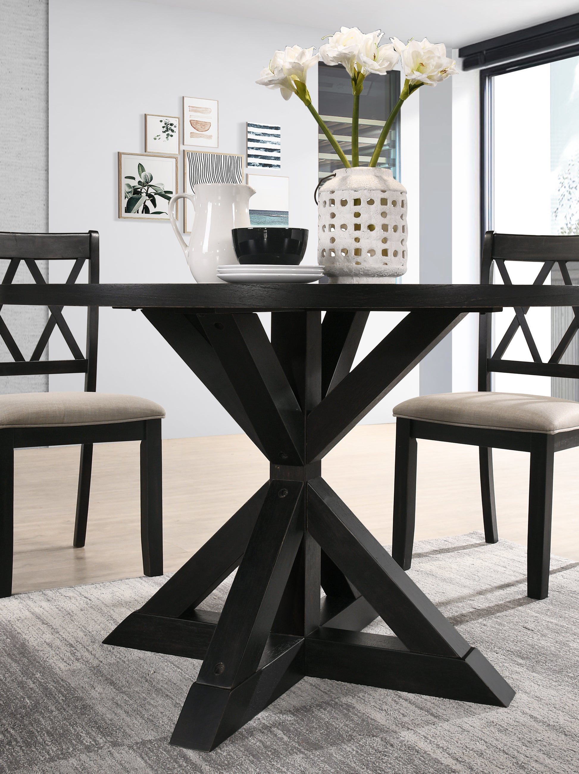 Dark wood pedestal dining table with crossbase design and upholstered chairs