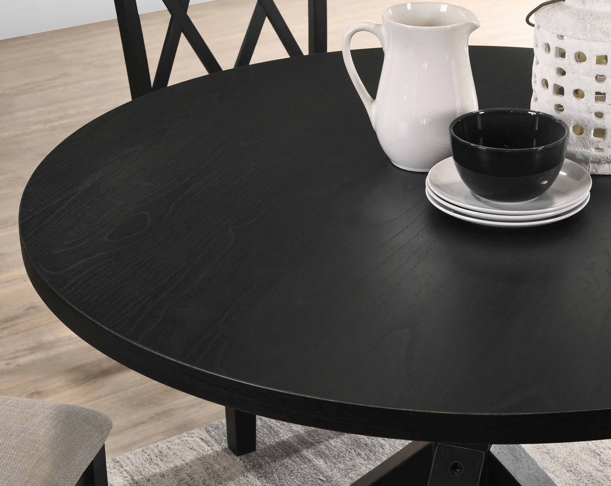 Black round dining table with wood grain detail