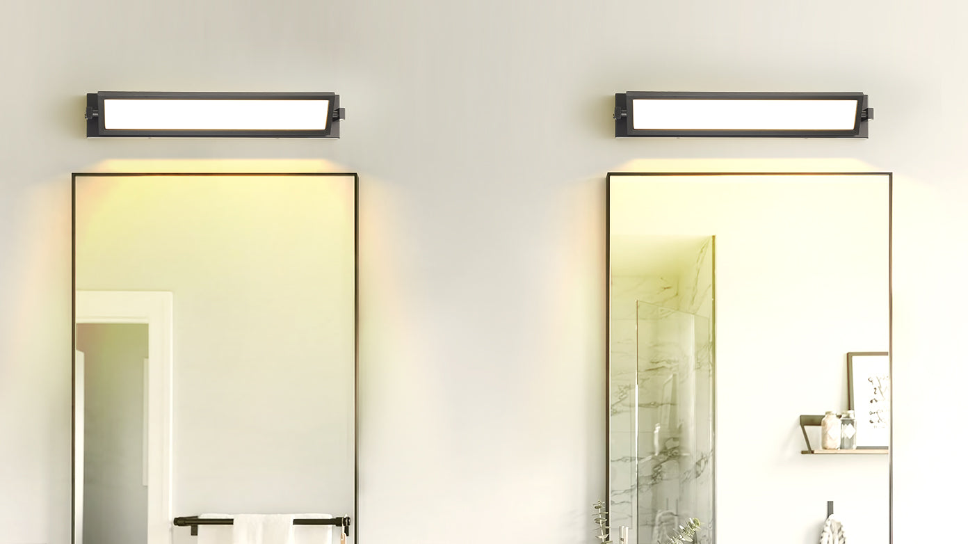 Modern rectangular vanity light with brushed nickel finish over a bathroom mirror
