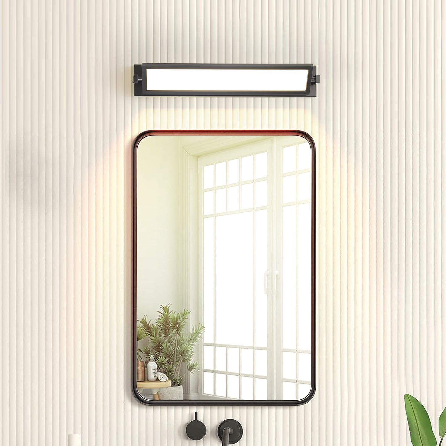 Modern black rectangular LED vanity light with warm illumination above a framed bathroom mirror