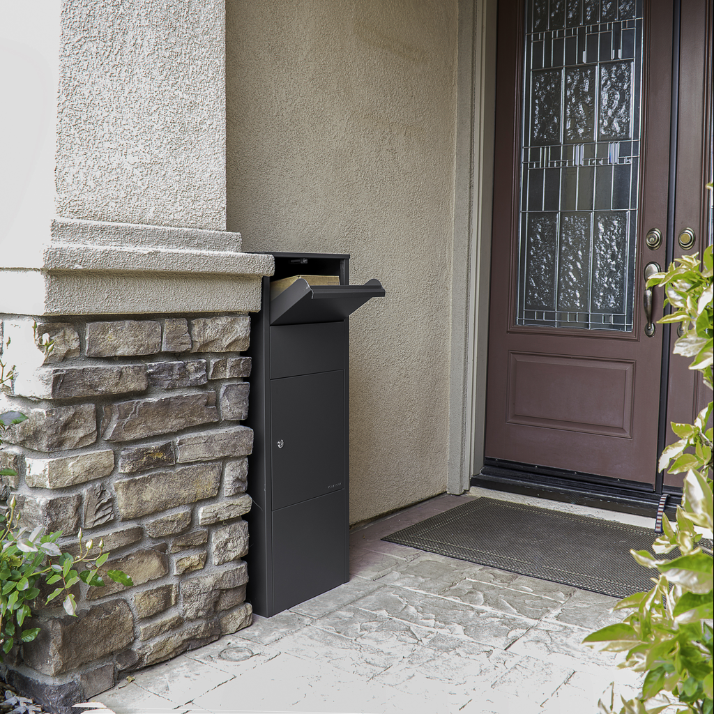 Sleek dark gray parcel delivery box with open drop slot on a stoneaccented porch