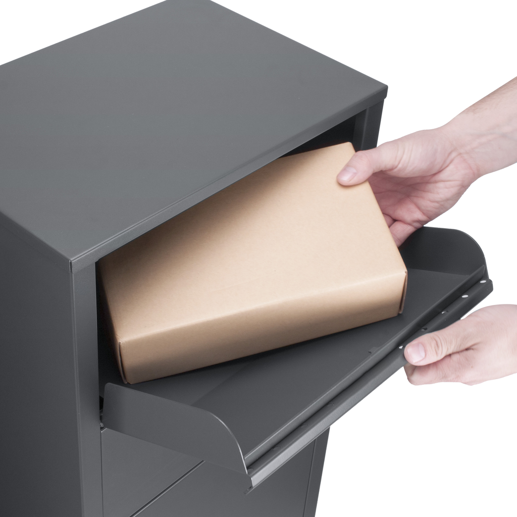 Hands placing a brown cardboard parcel into a charcoal grey parcel box with a pullout tray