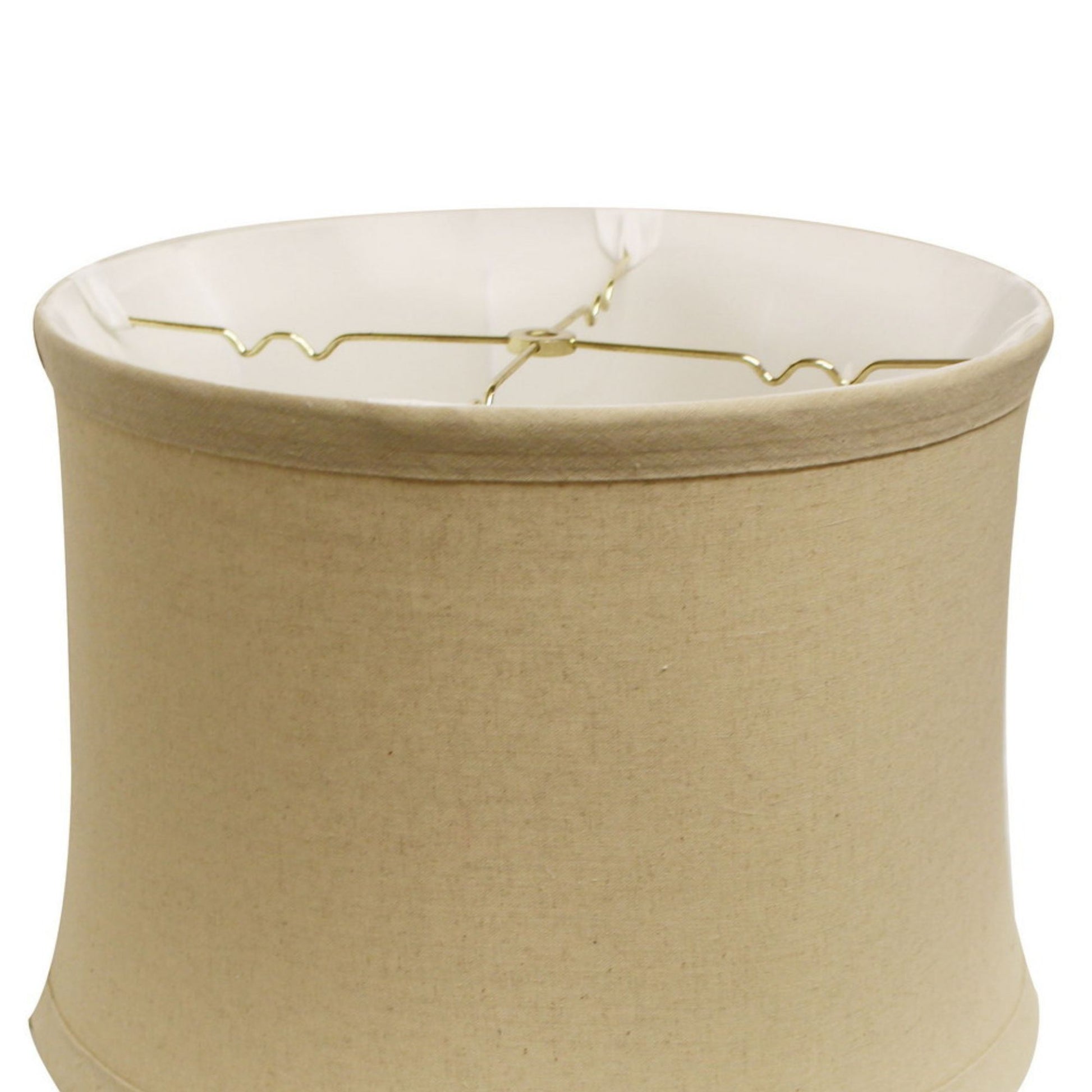 Tan fabric drum lampshade with gold harp hardware visible inside