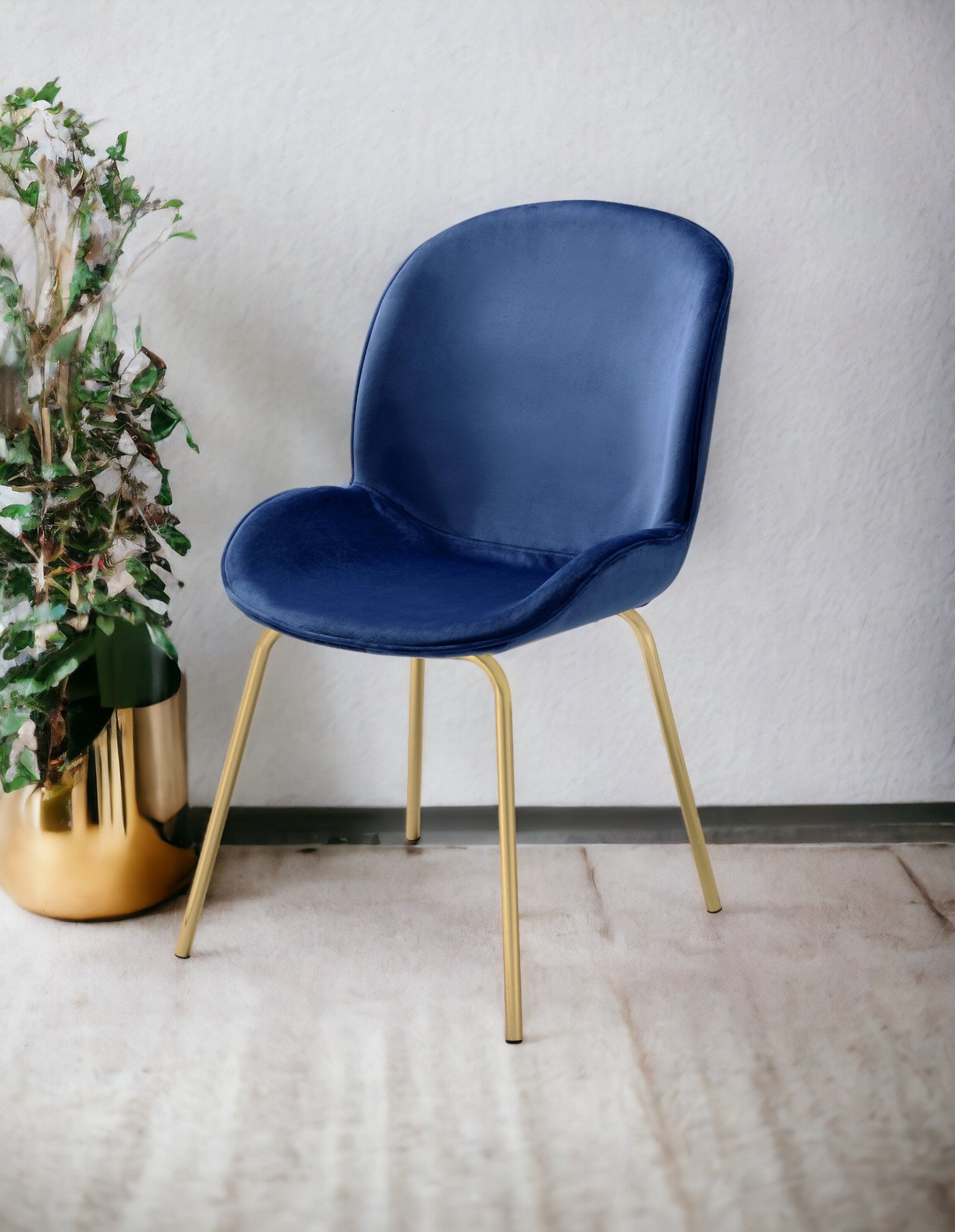 Deep blue velvet accent chair with sleek gold legs perfect for modern living rooms