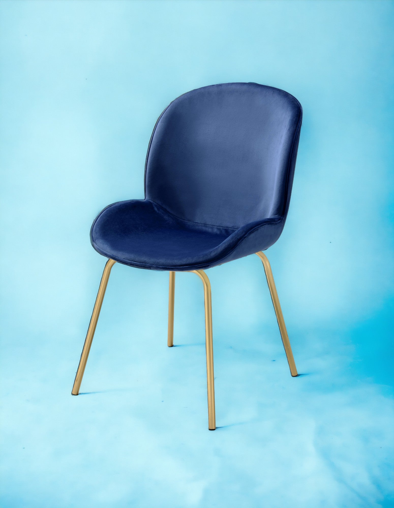Deep navy velvet accent chair with sleek gold metal legs