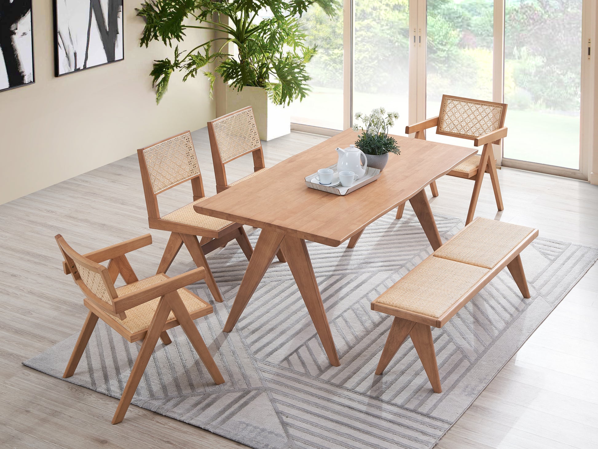 Light wood dining table and chairs with woven seats