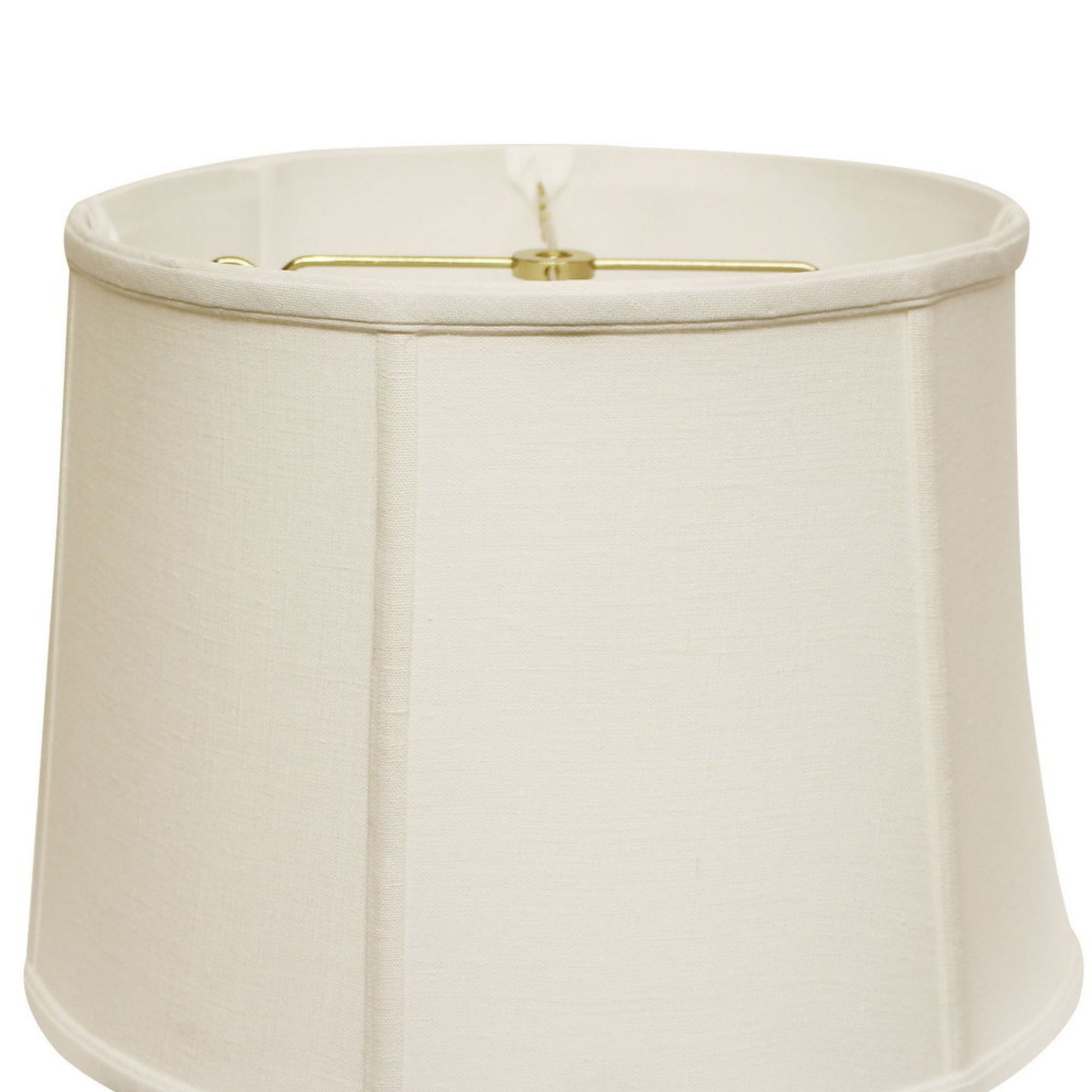 Cream linen drum lampshade with brass harp attachment for a classic table lamp