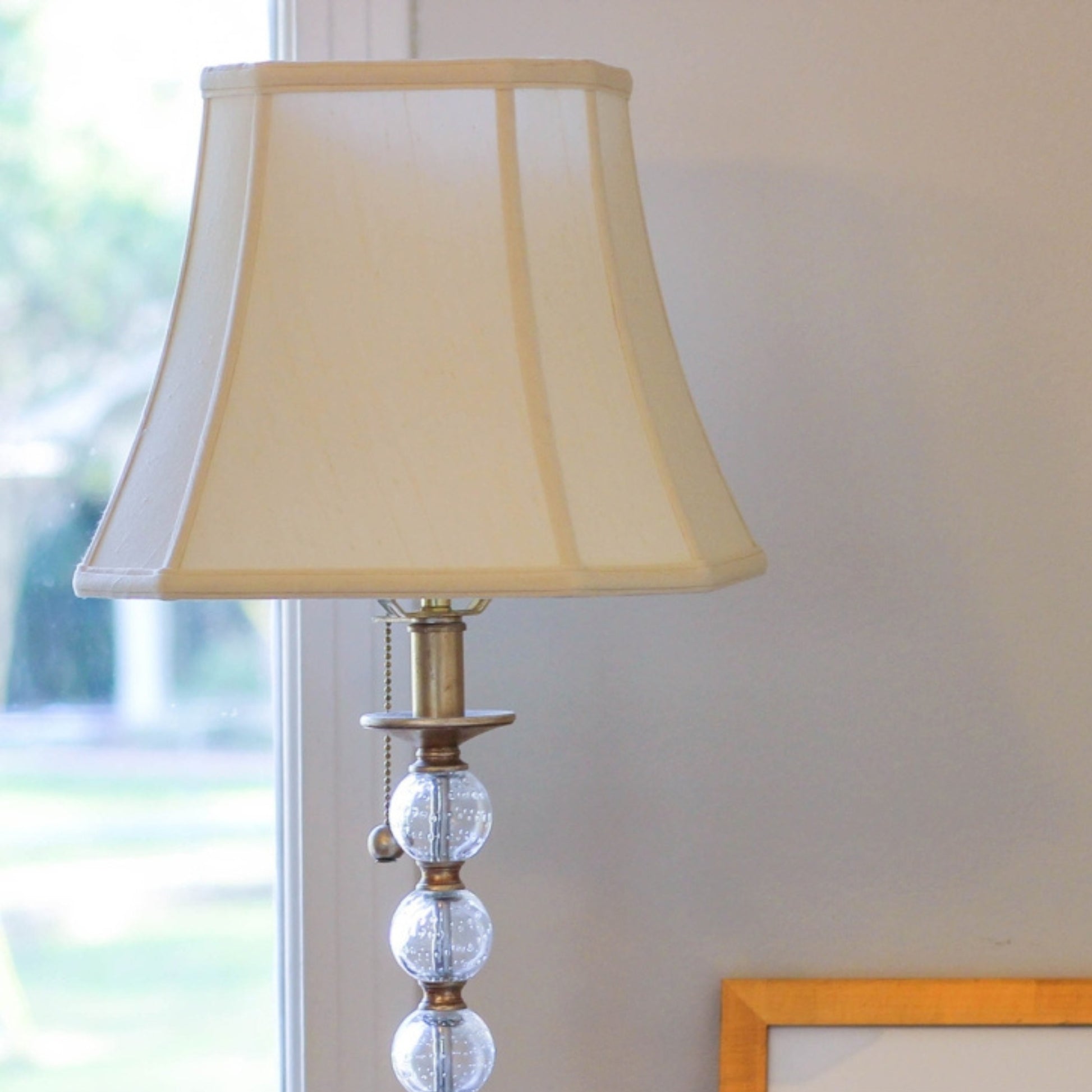 Elegant cream lampshade with beaded glass base ideal for living room ambiance