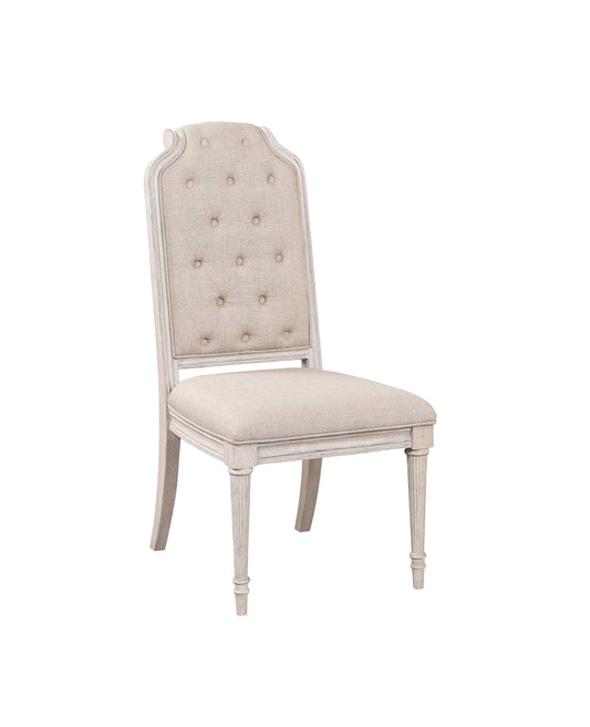 Tufted linen dining chair with distressed white wood frame and carved legs
