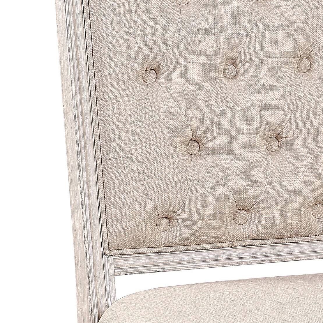 Cream upholstered tufted dining chair back with distressed white frame