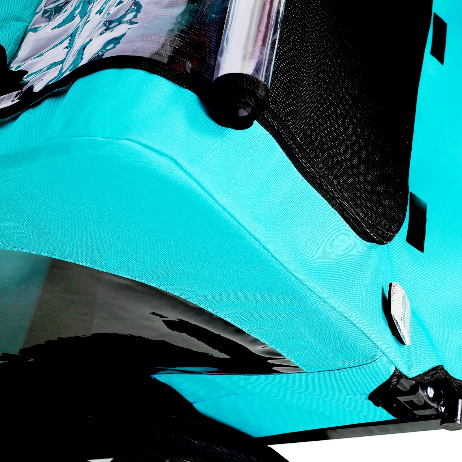 Turquoise bicycle trailer canopy detail with reflective strip and black mesh window