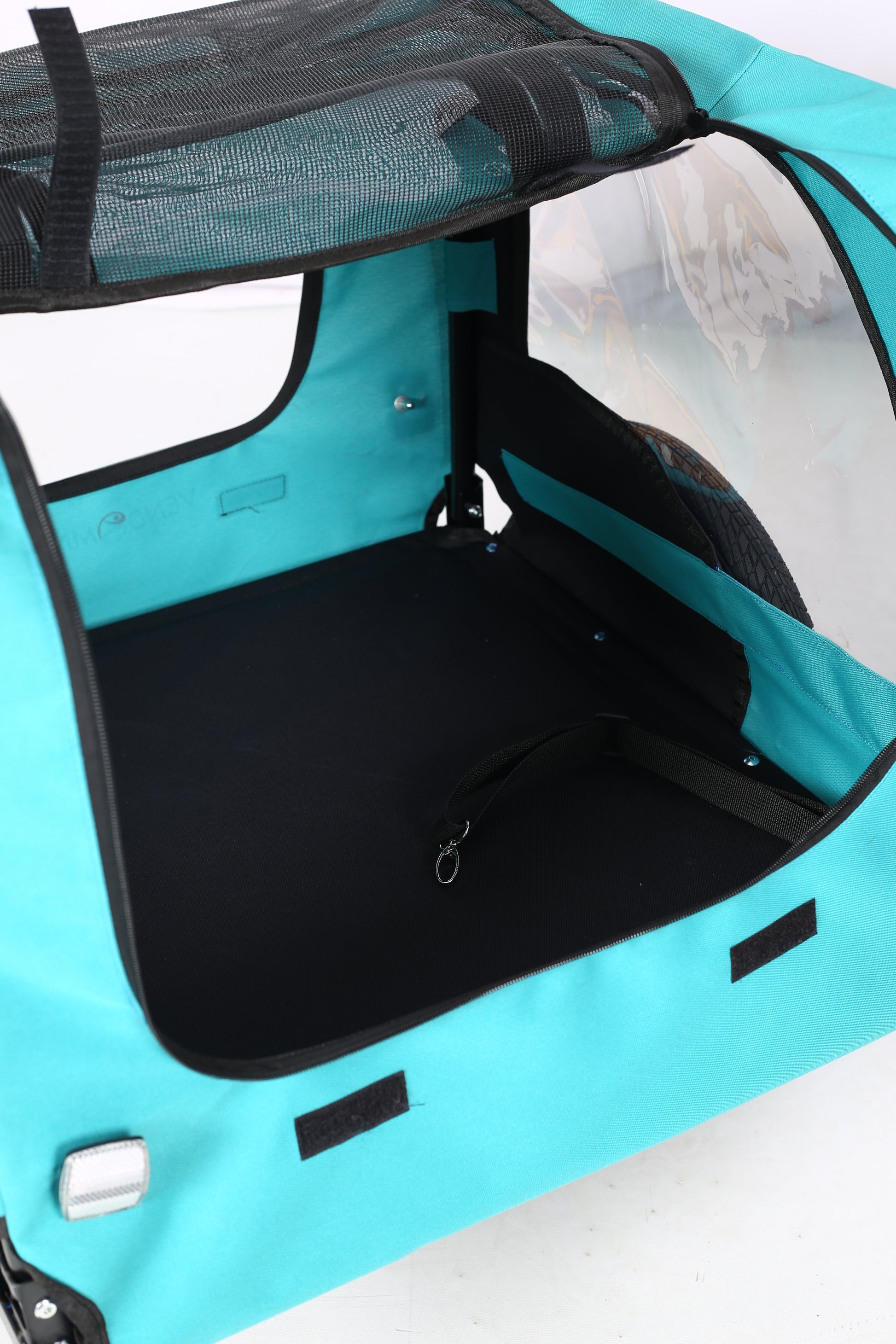 Open top view of a turquoise pet stroller showcasing interior black padding and mesh ventilation for pet comfort