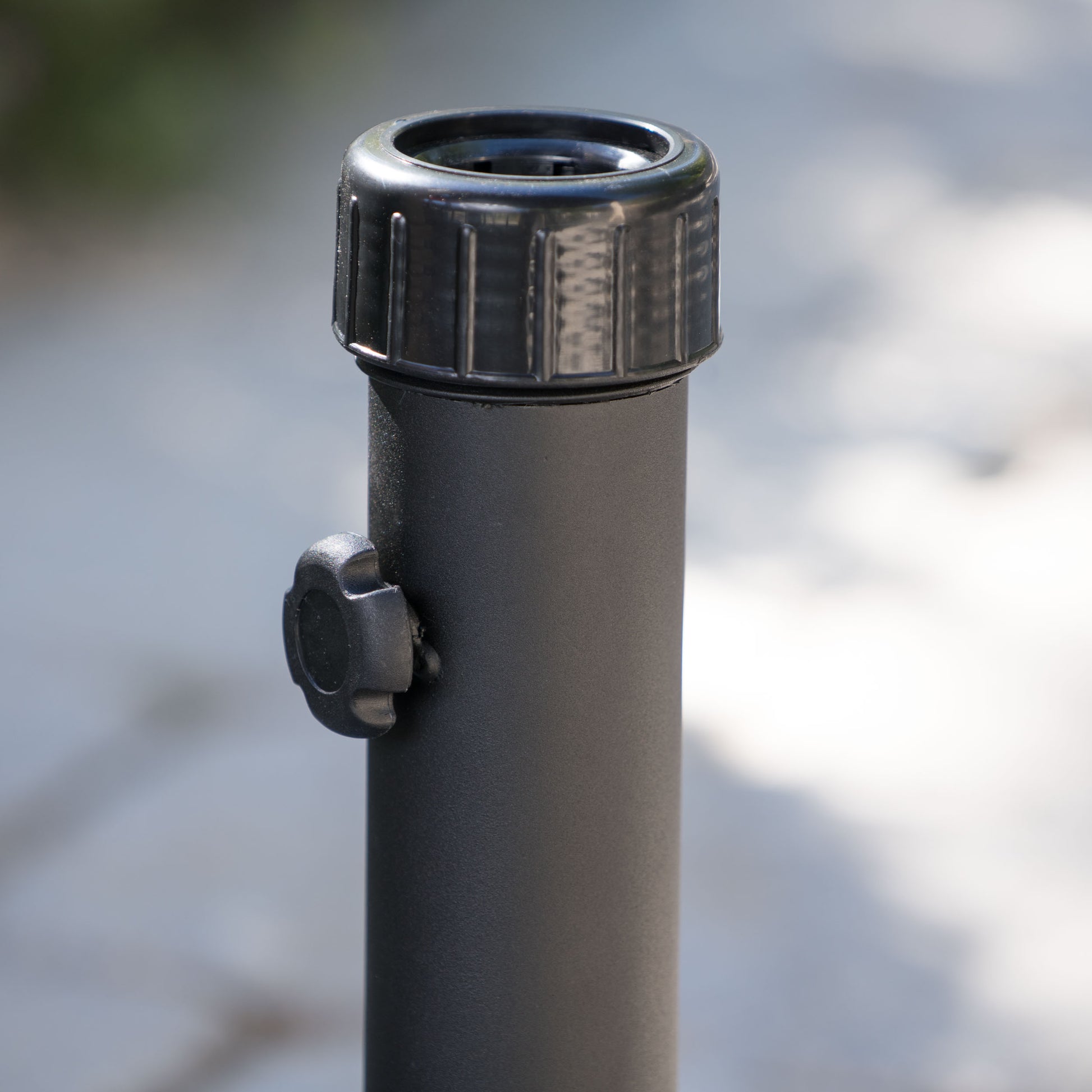 Black metal umbrella pole with adjustable knob for outdoor use