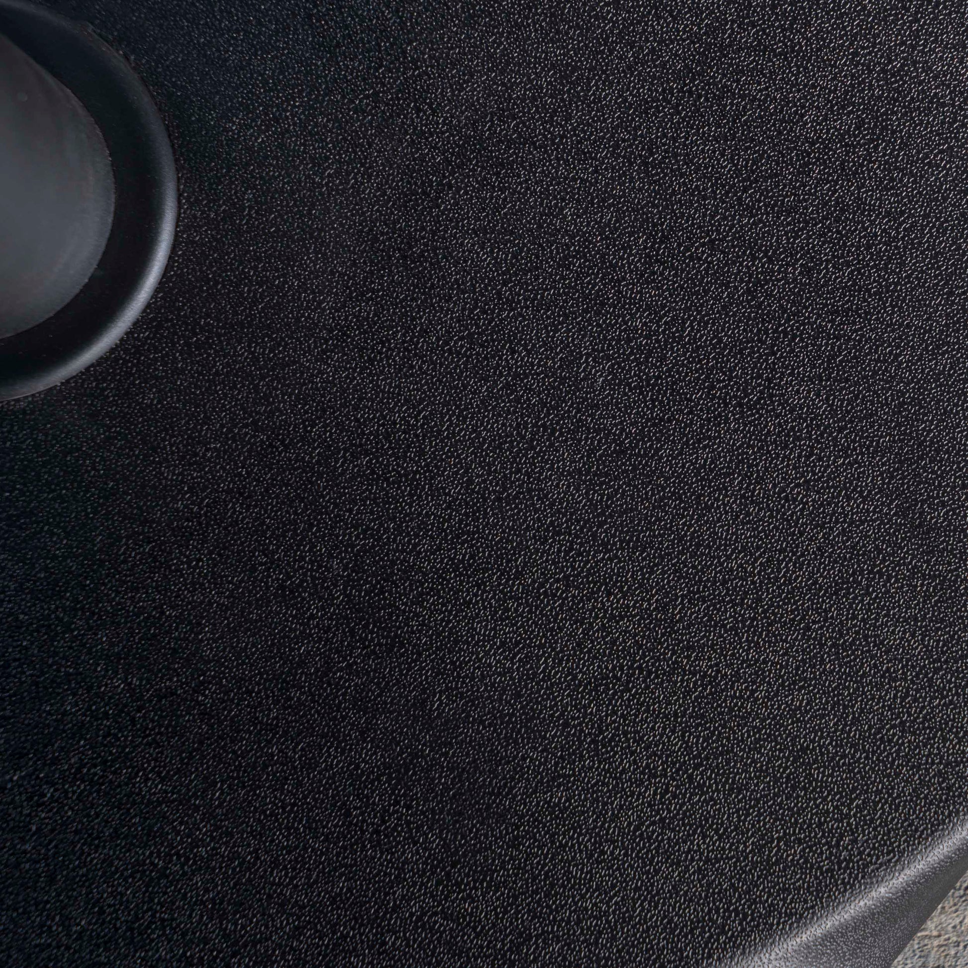 Closeup of textured black material possibly a rugged phone case showing detailed surface pattern