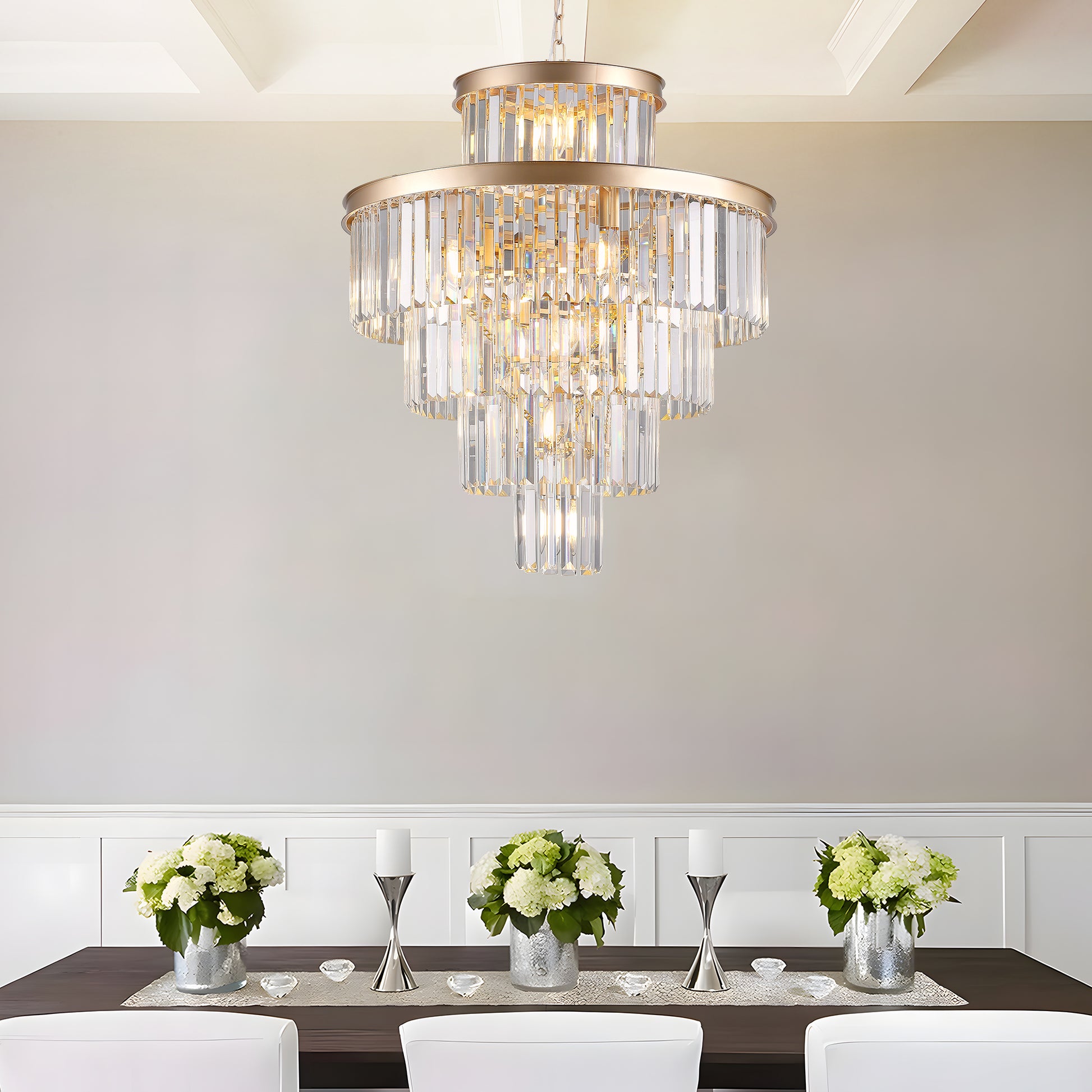 Luxurious gold crystal tiered chandelier cascading light over a dining table