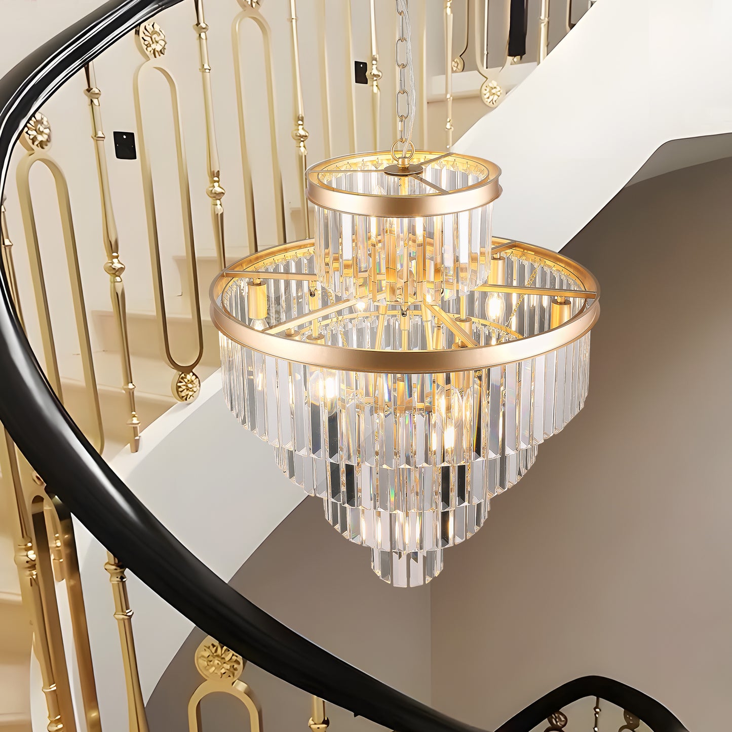 Glamorous tiered crystal chandelier with gold accents hanging in a grand staircase