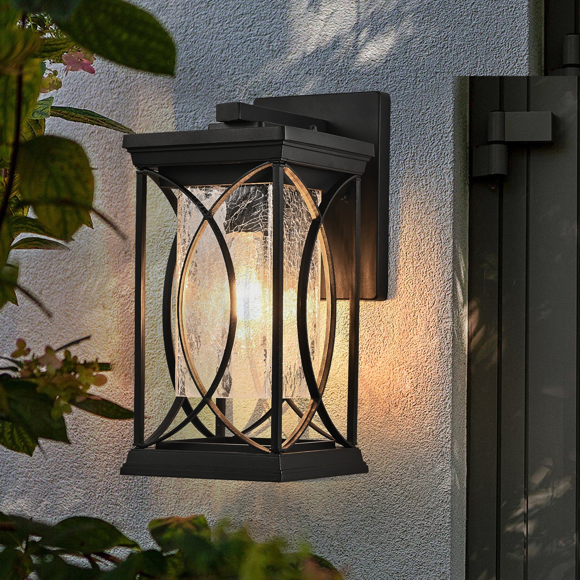 Black metal outdoor lantern with clear textured glass and decorative scrollwork