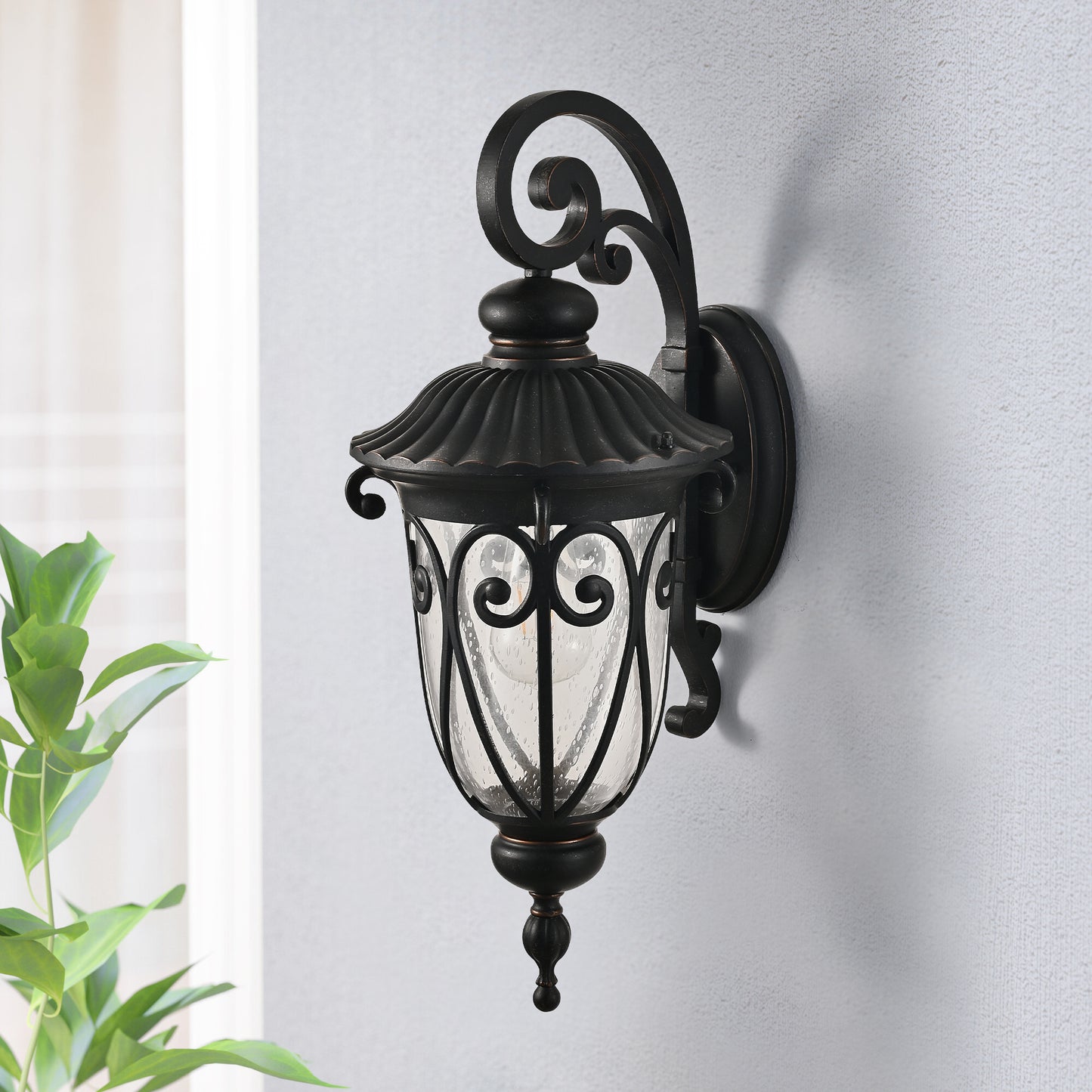 Classic bronze outdoor wall light with seeded glass and ornate scrollwork design