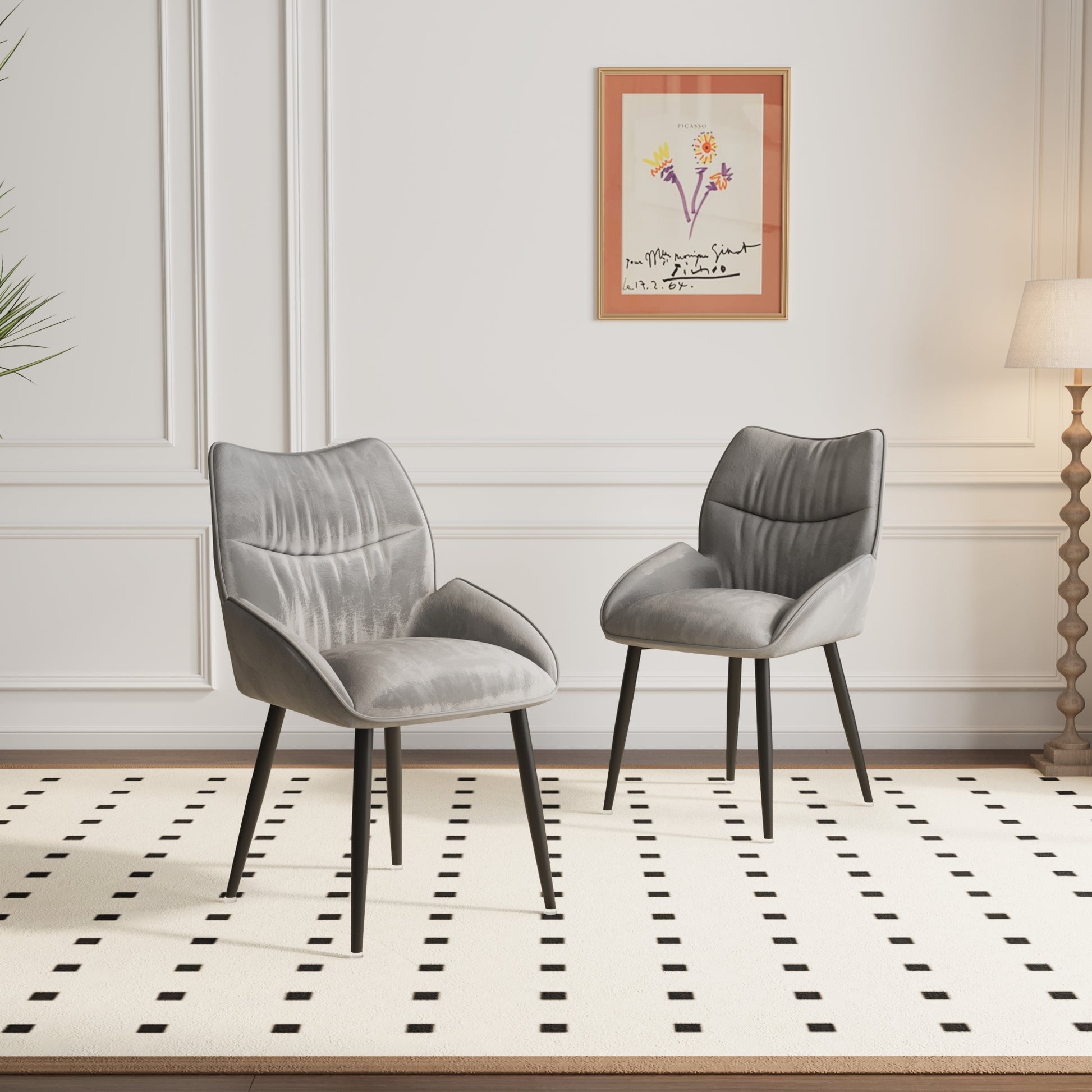Plush grey velvet accent chair with a modern silhouette and black tapered legs
