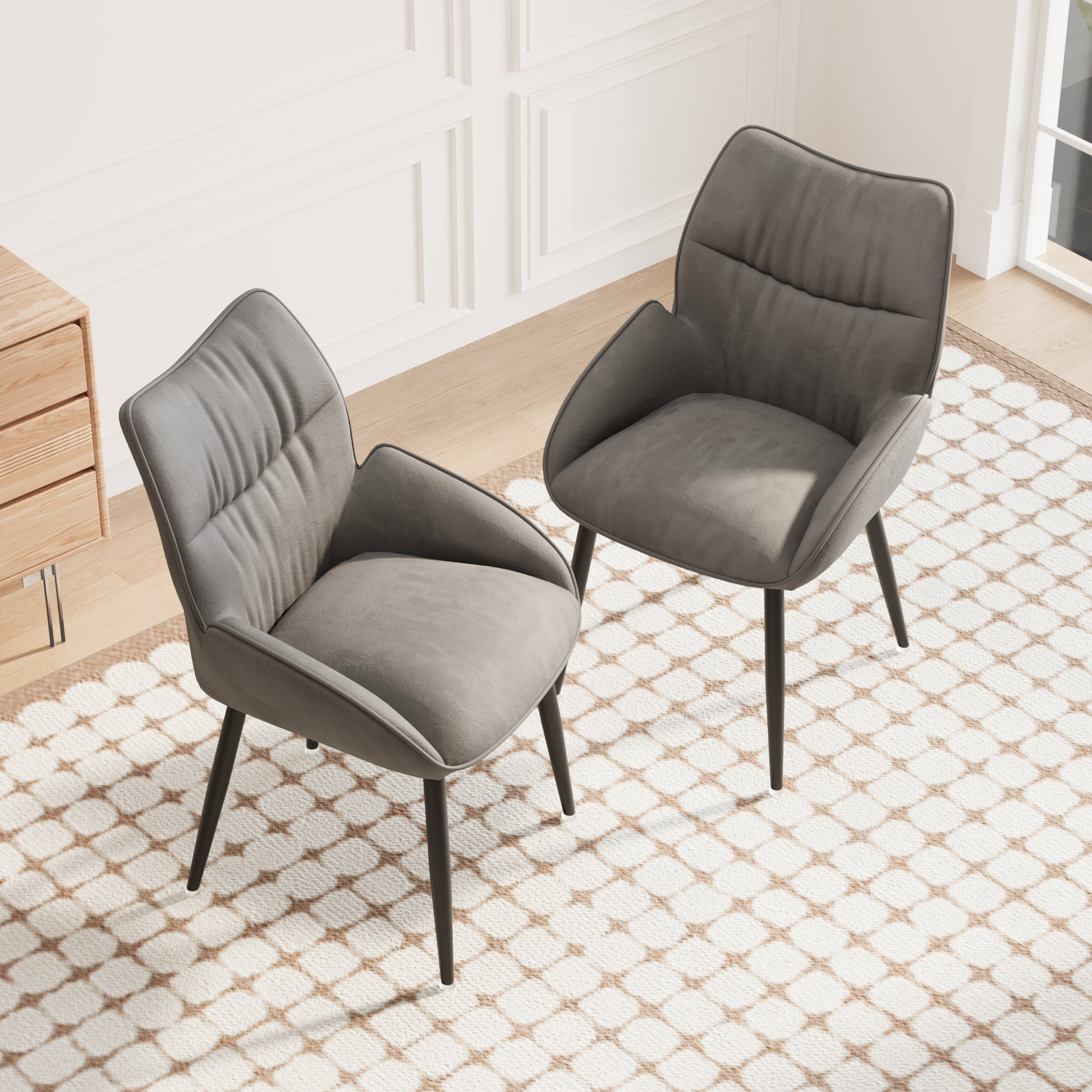 Modern grey upholstered dining chairs with tufted seats and black metal legs