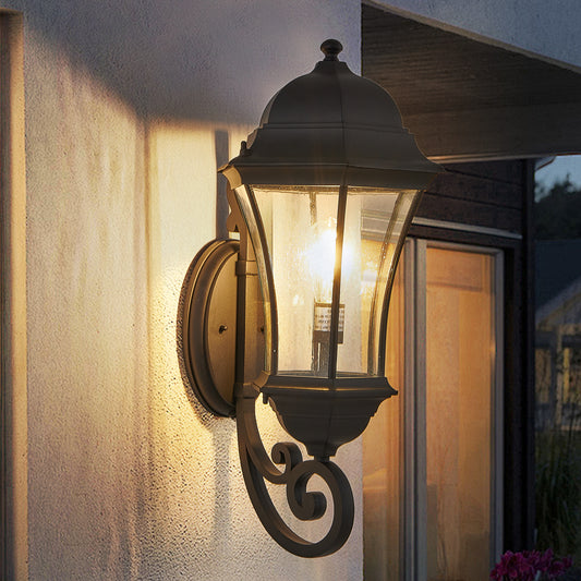 Bronze traditional outdoor wall lantern with clear seeded glass and ornate scroll arm