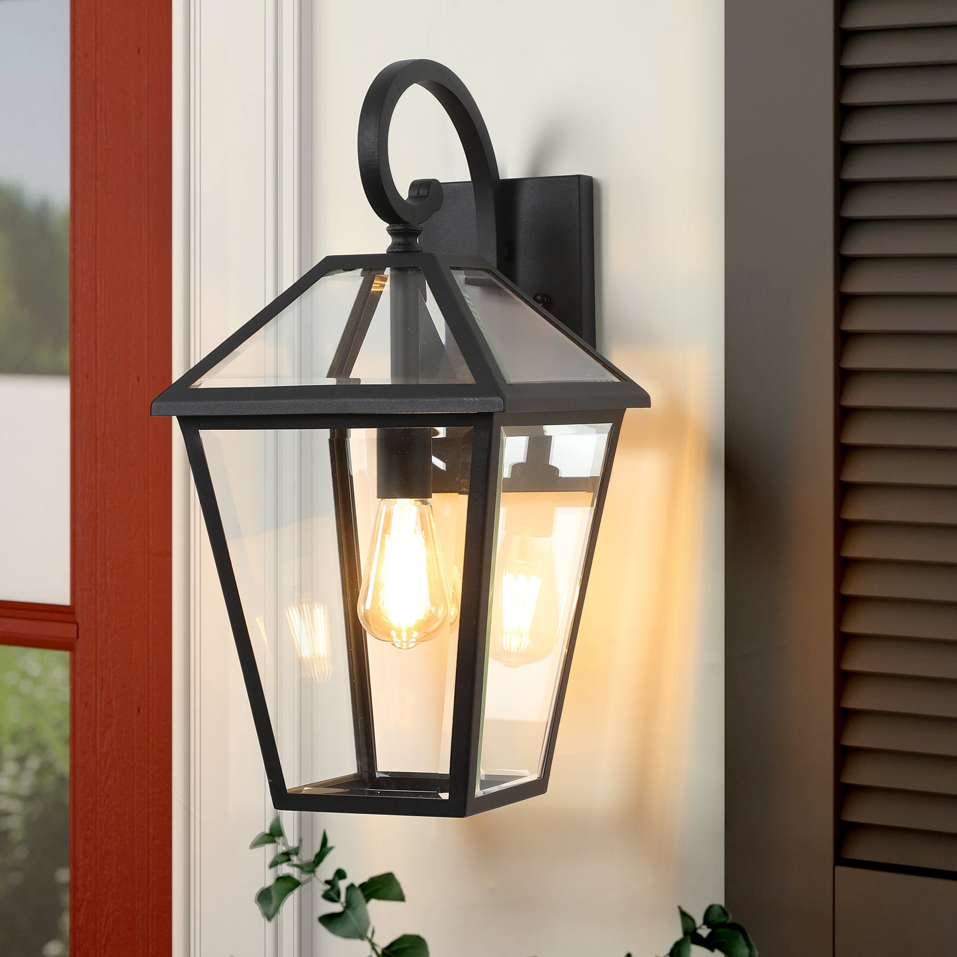 Black metal outdoor lantern with glass panels and Edison bulb