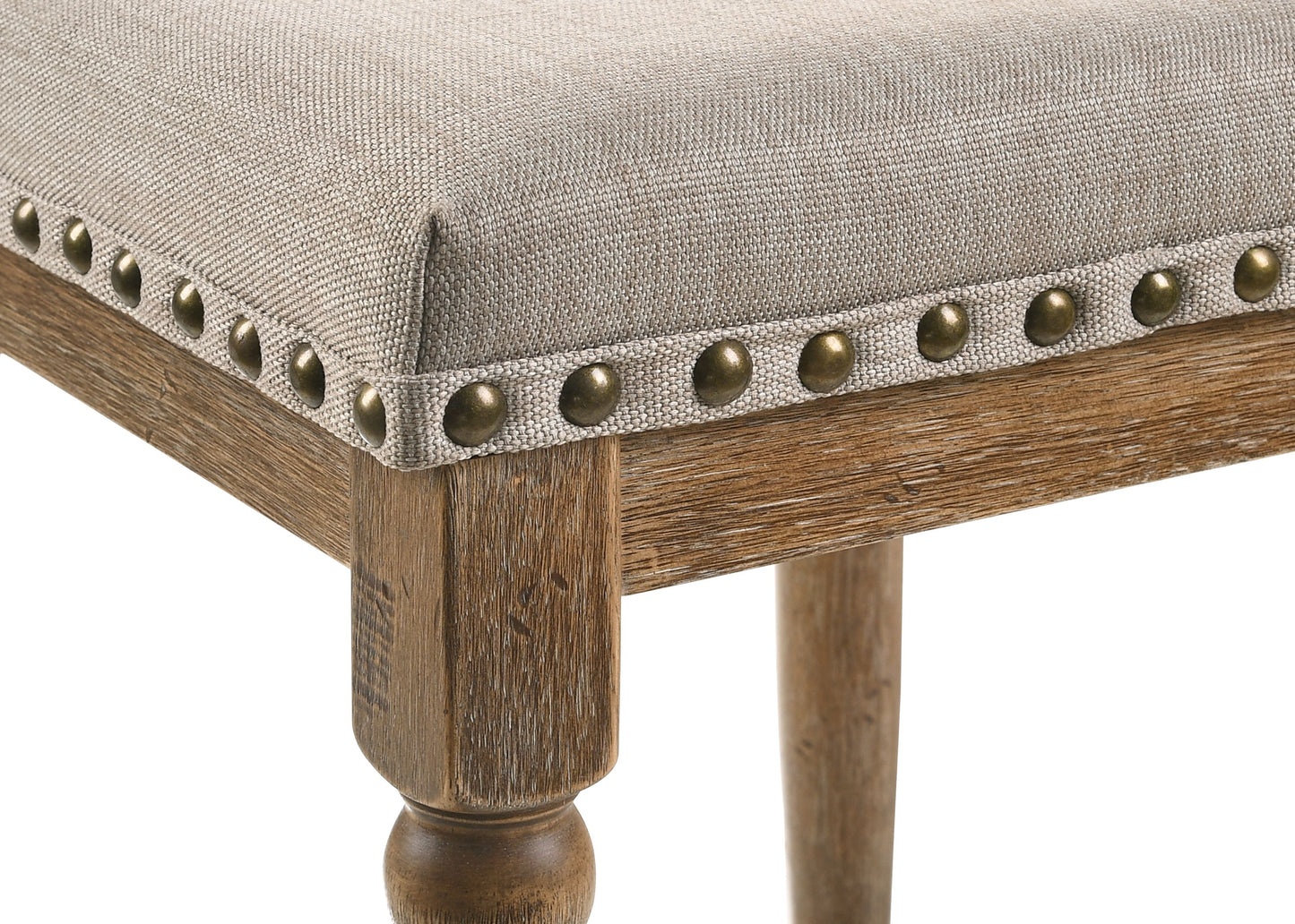 Beige upholstered stool with decorative nailhead trim and distressed wood legs