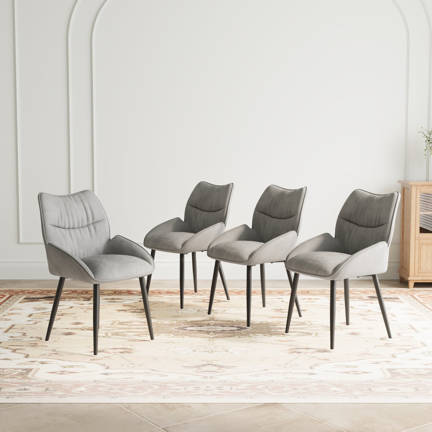 Set of four grey velvet dining chairs with black metal legs