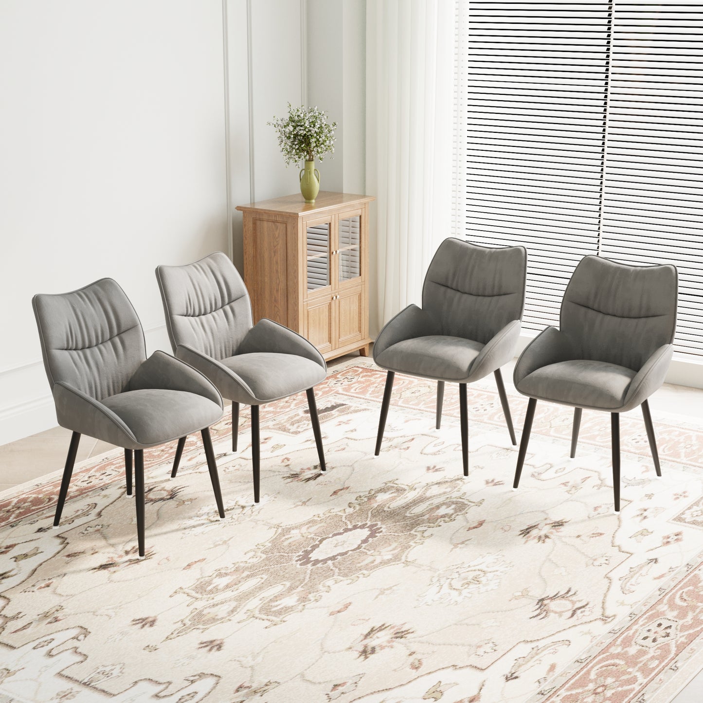 Set of four grey velvet dining chairs with black metal legs providing a modern accent