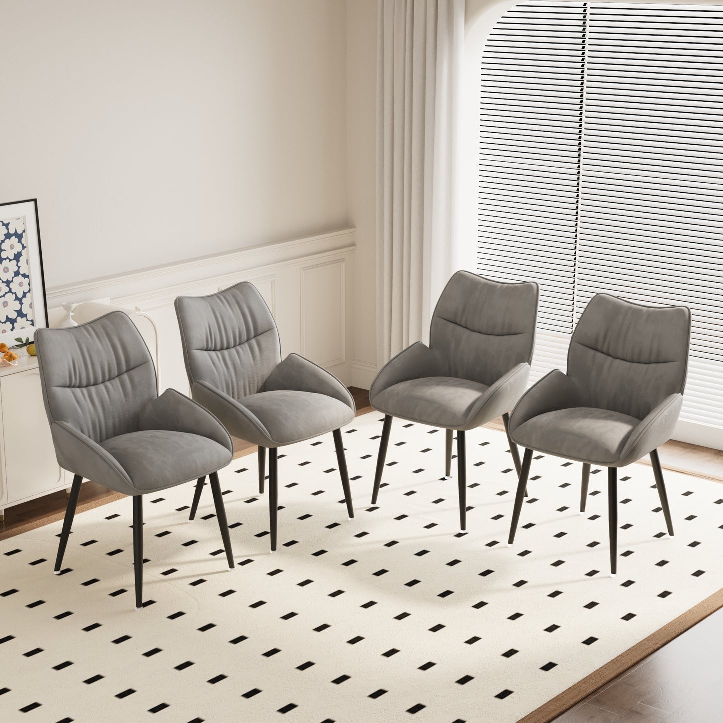 Four grey upholstered dining chairs with tufted backs and black tapered legs