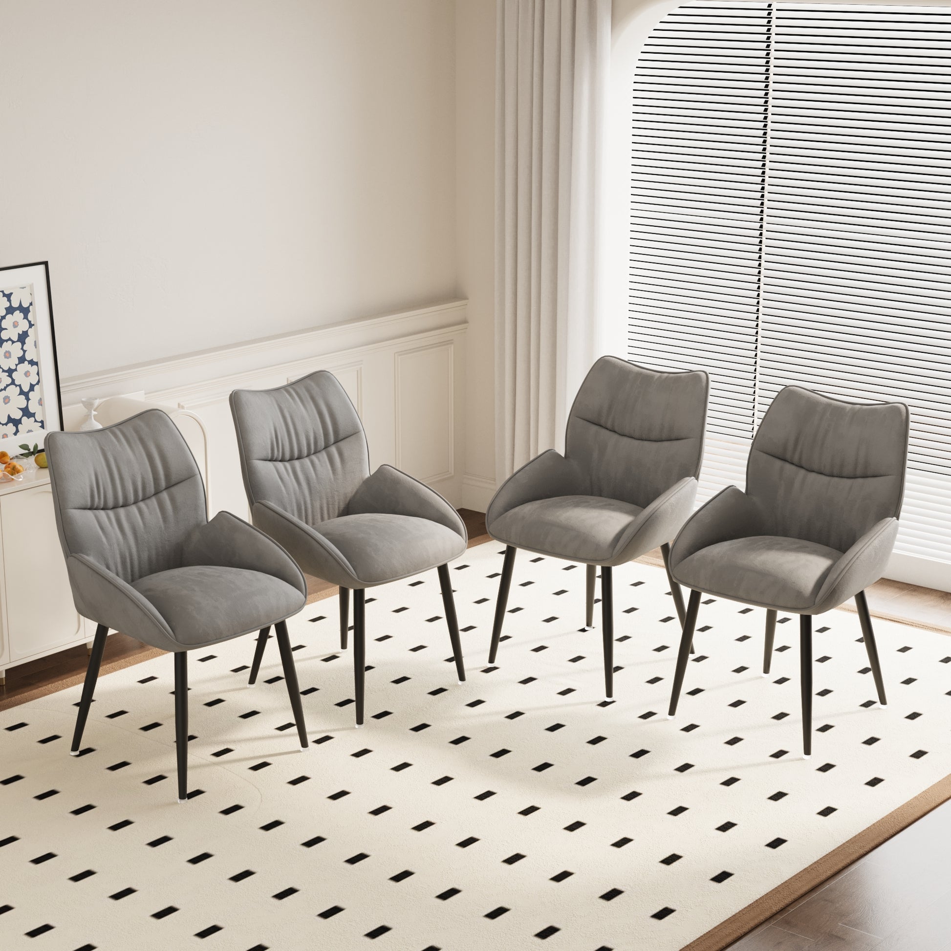 Four grey upholstered dining chairs with tufted backs and black tapered legs